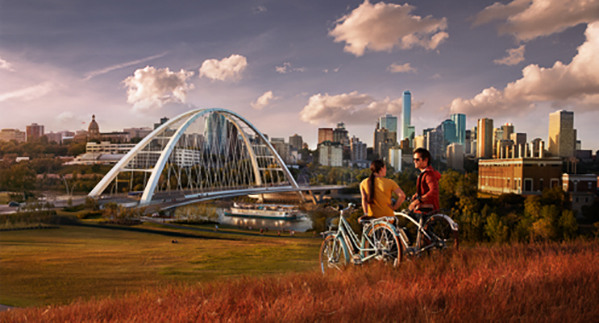 Two people standing next to bicycles overlooking Edmonton Metro region